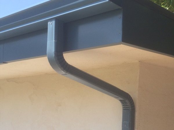 City Seamless K-style seamless rain gutter with downspout routing on a Southern Nevada home.