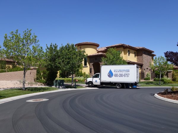 City Seamless rain gutter installation crew and equipment photo.