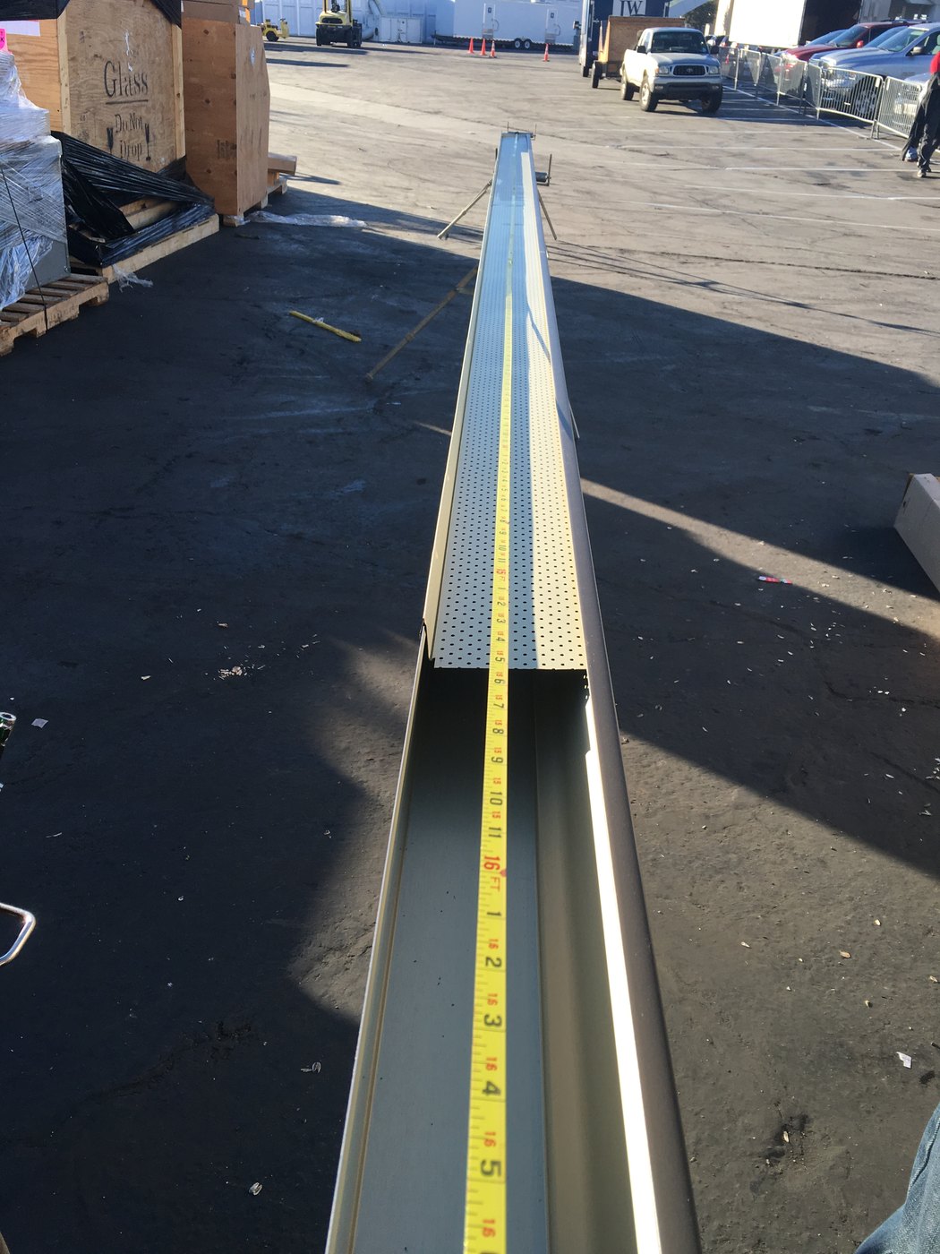 Long seamless gutter run measured before installation